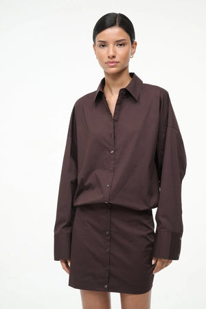 Cynthia Dress in Earth by Staud shown in a flat lay, emphasizing its rich earthy color and stylish mini dress construction.