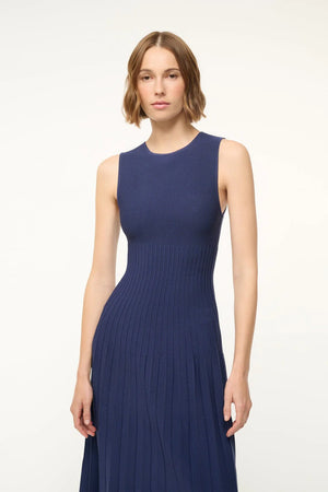 Flat lay of the Elyse Dress in Navy, displaying its vibrant color and soft fabric composition.