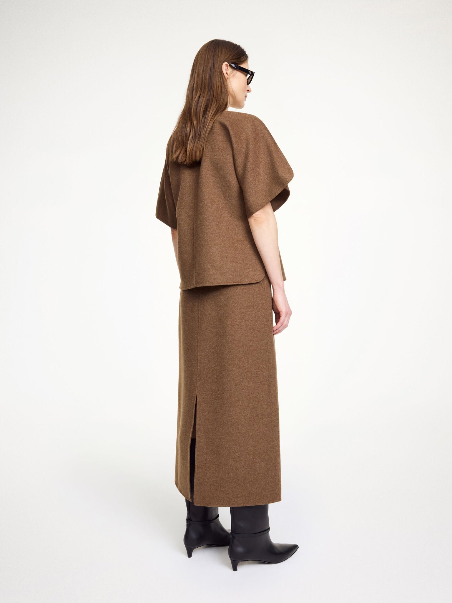 Palomie Midi Skirt in Dark Brown Melange styled elegantly with a blazer for a polished evening outfit by By Malene Birger.