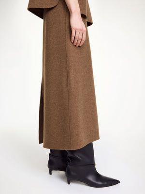 Model wearing the Palomie Midi Skirt in Dark Brown Melange, highlighting its flattering midi length and body-skimming fit.