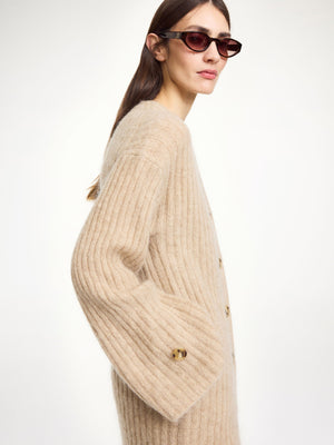 Cimonello Maxi Cardigan in Twill Beige draped elegantly, highlighting its bold maxi silhouette.