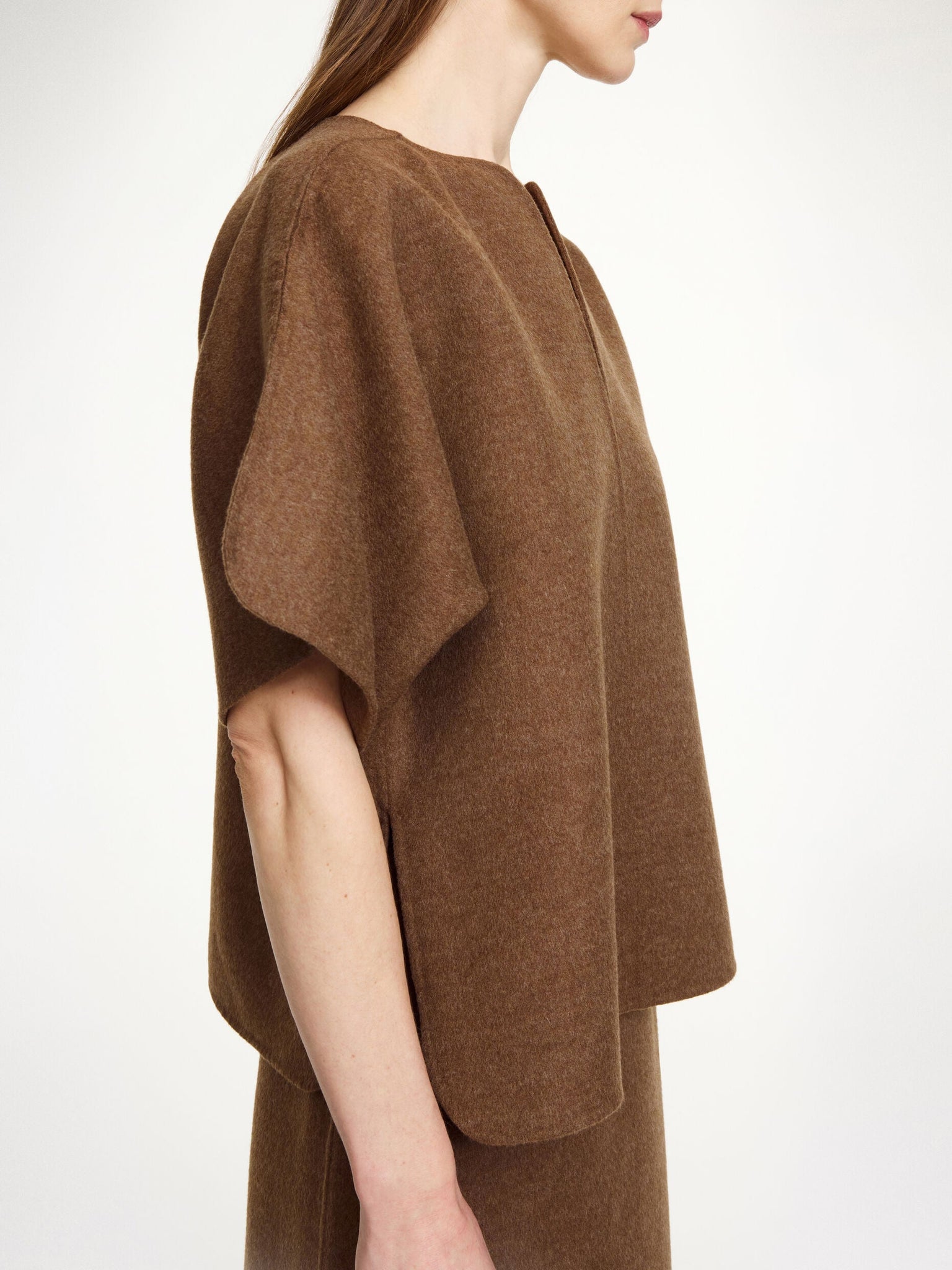 Model wearing the Calle Wool Blouse in Dark Brown Melange by By Malene Birger, combining elegance with warmth for fall fashion.