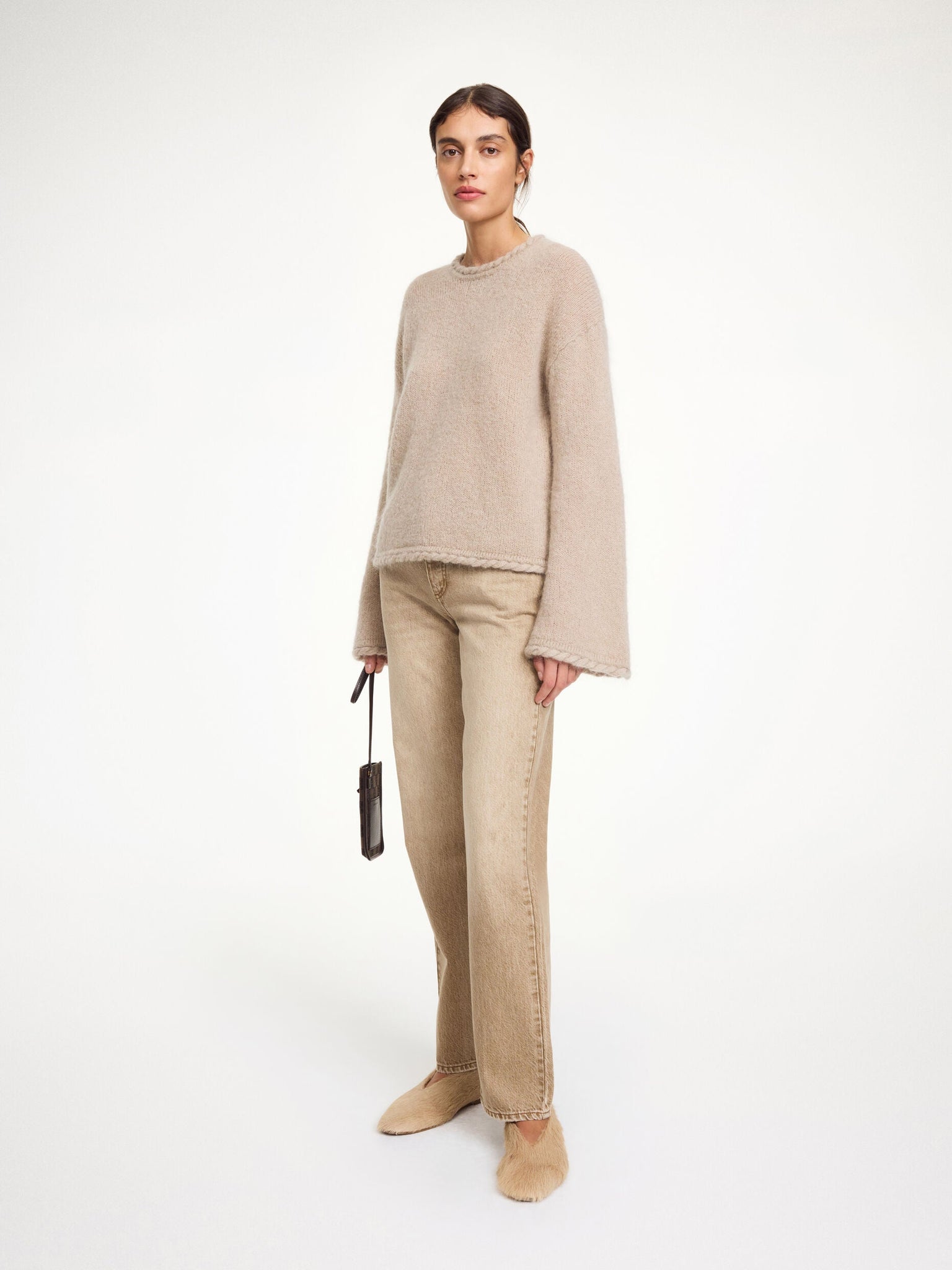 Side view of the Cierra Sweater in Cobblestone, highlighting dropped shoulders and elongated sleeves for a relaxed fit.