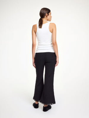 Back view of Mafaldana Boucle Trousers in Black showing the zip, hook, and button closure.
