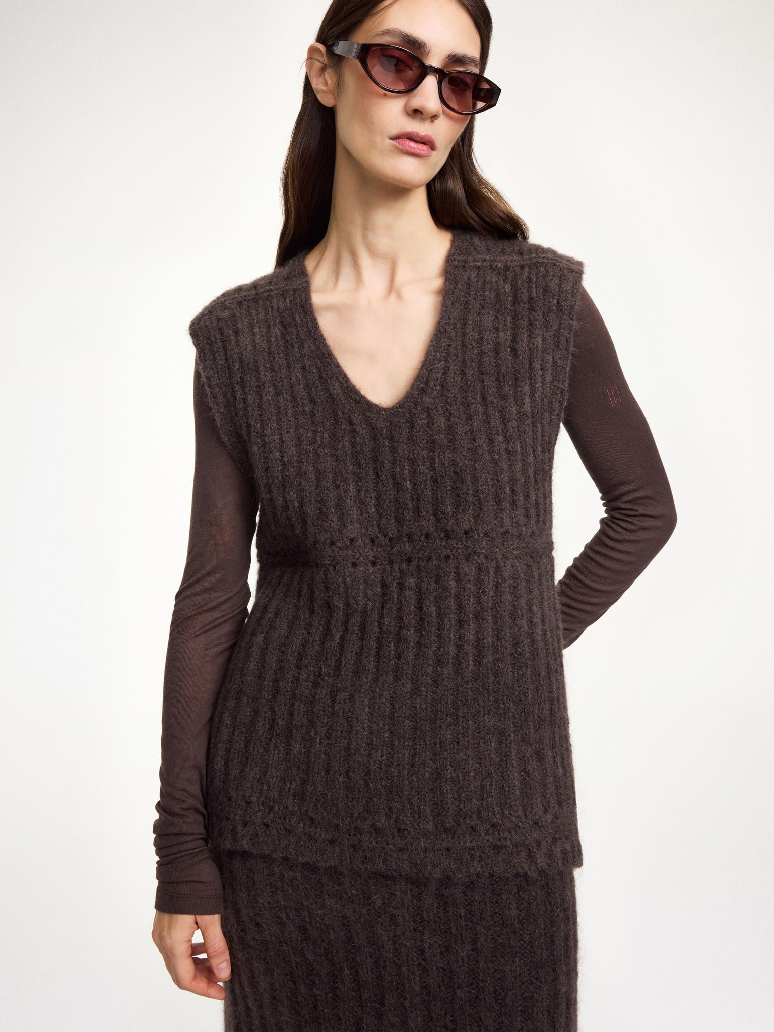 Back view of the Revna Vest in Carafe, displaying its slightly dropped shoulders and side slits for a modern silhouette.