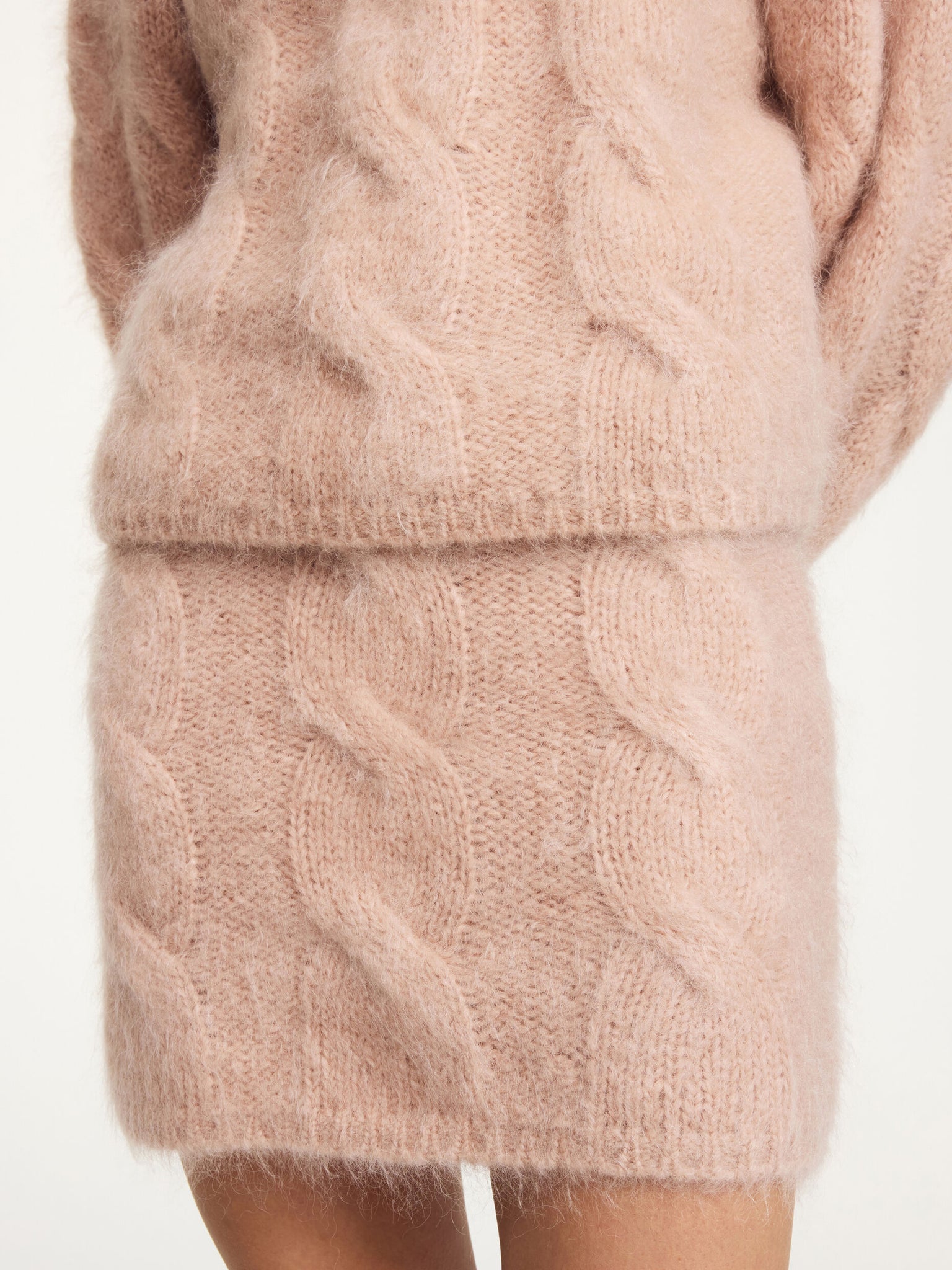 Eliotta Mini Skirt in Rose Dust displayed on a plain background, emphasizing its warm color and luxurious fabric.