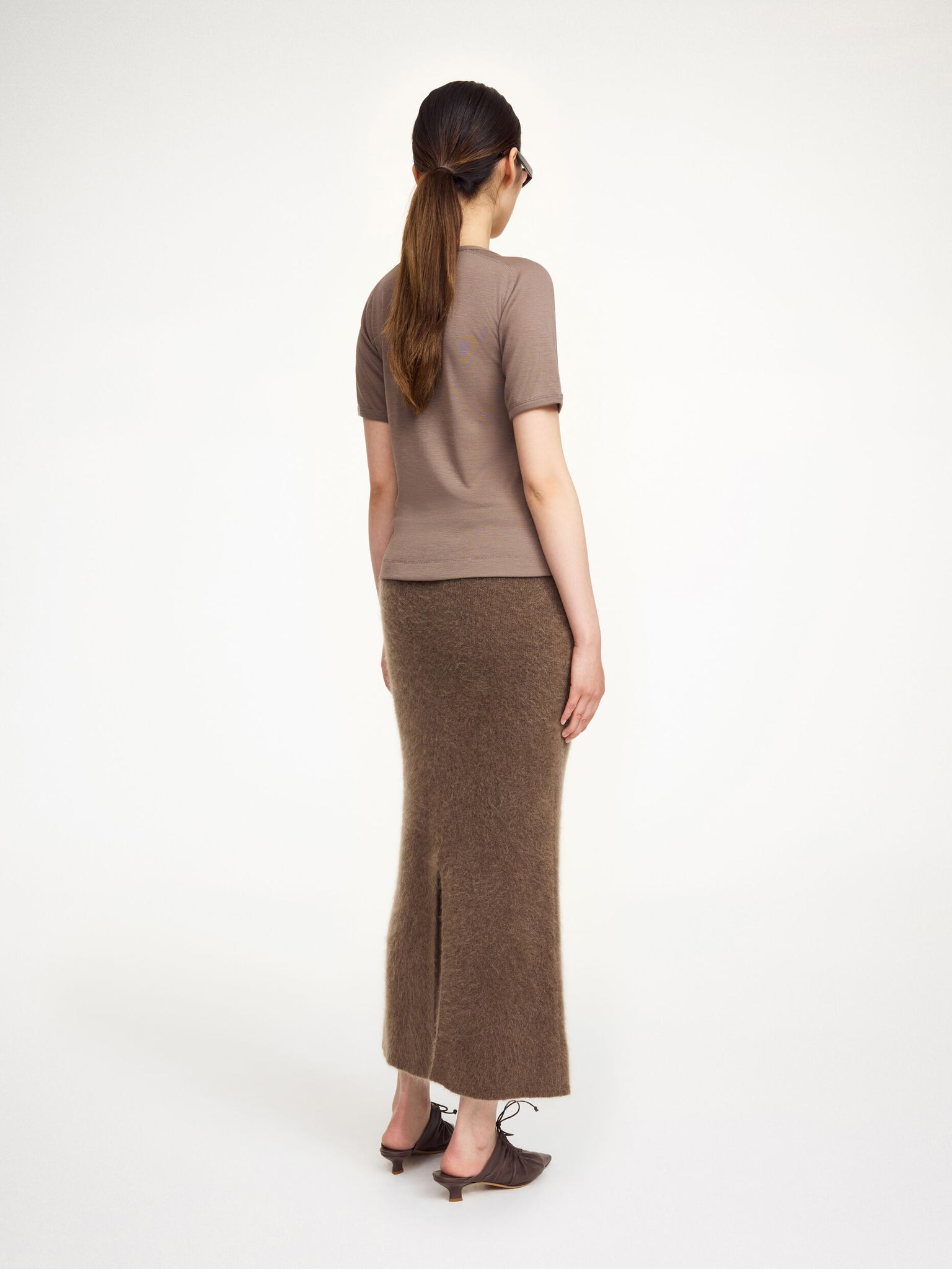 Model wearing the Estille Skirt in Chocolate Chip by By Malene Birger, styled for a winter outfit.