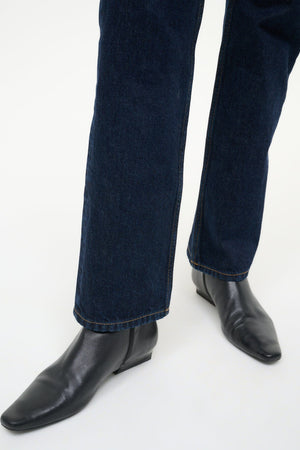 Wally Flat Ankle Boot in Black on a model, showcasing how to style it for a trendy look.