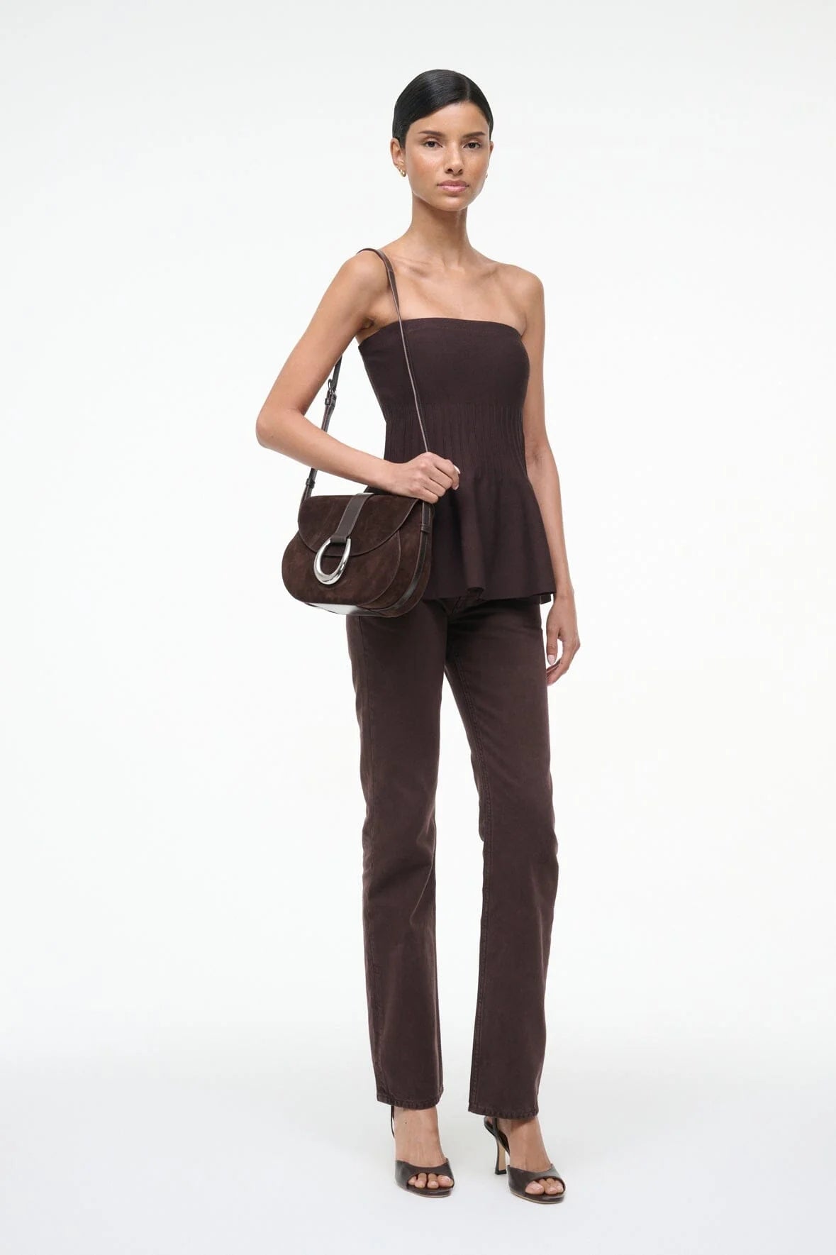Fashion model wearing the Staud Evie Top in Earth, highlighting its compact tube style.