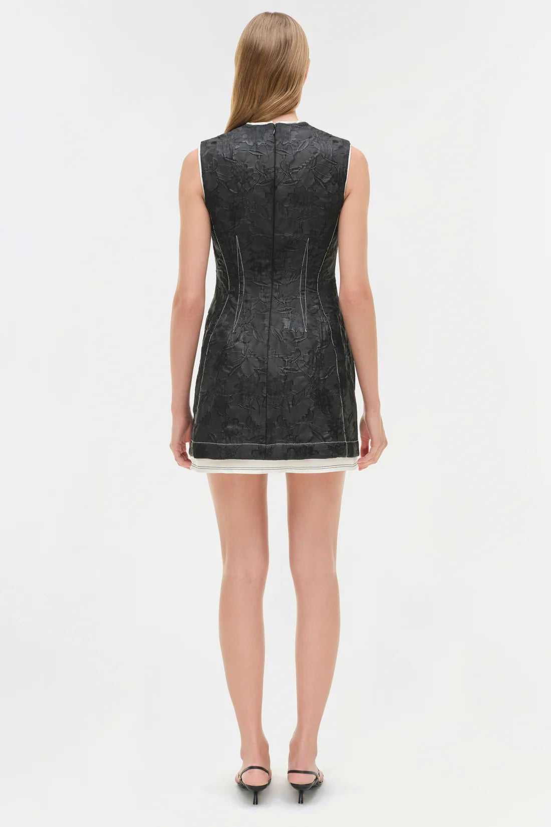 Back view of the Audrina Jacquard Mini Dress in Black by Simkhai, illustrating the detail in construction and fit.