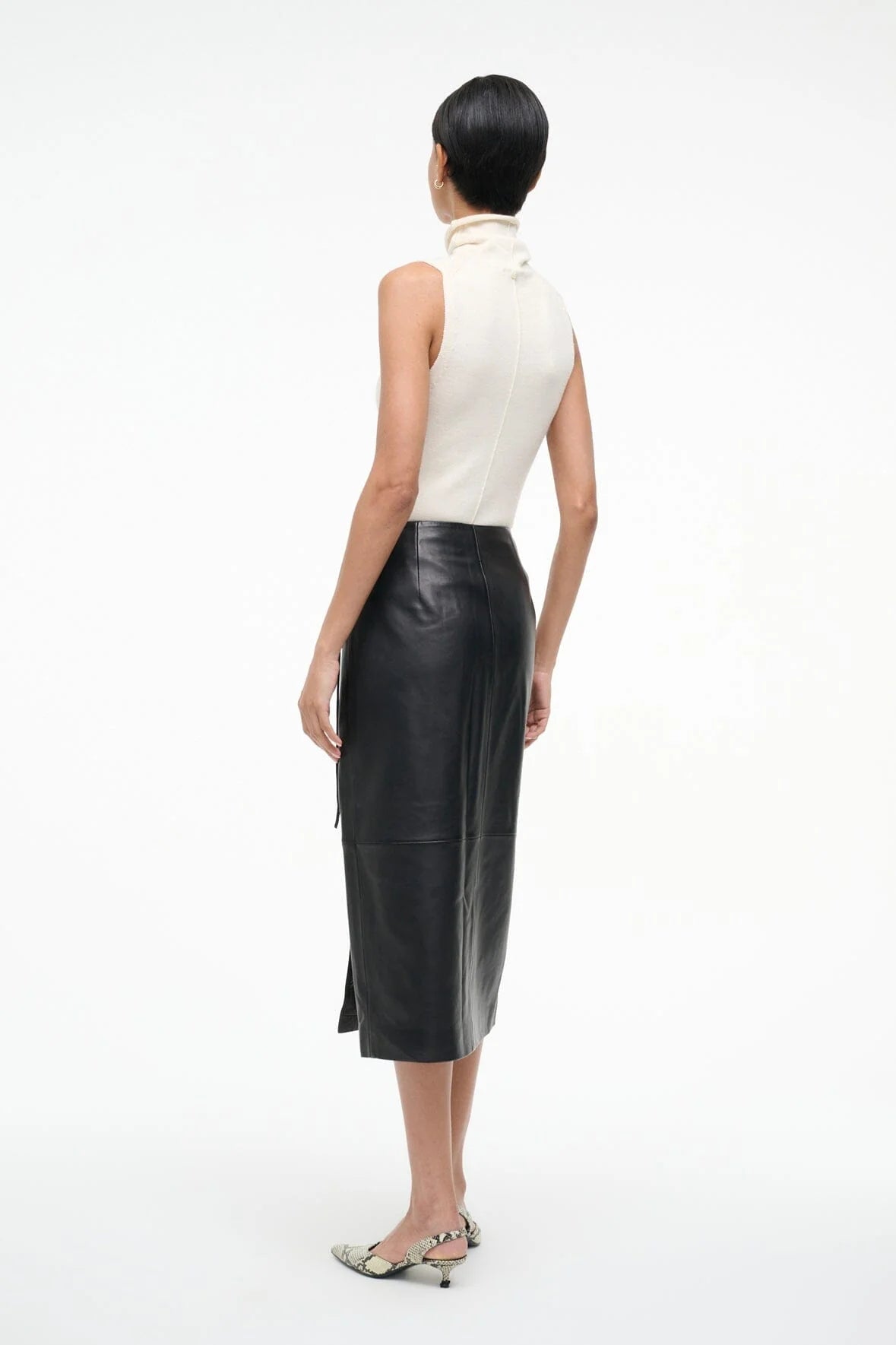 Back view of the Roman Leather Wrap Skirt in Black by Staud, revealing its minimalistic design.