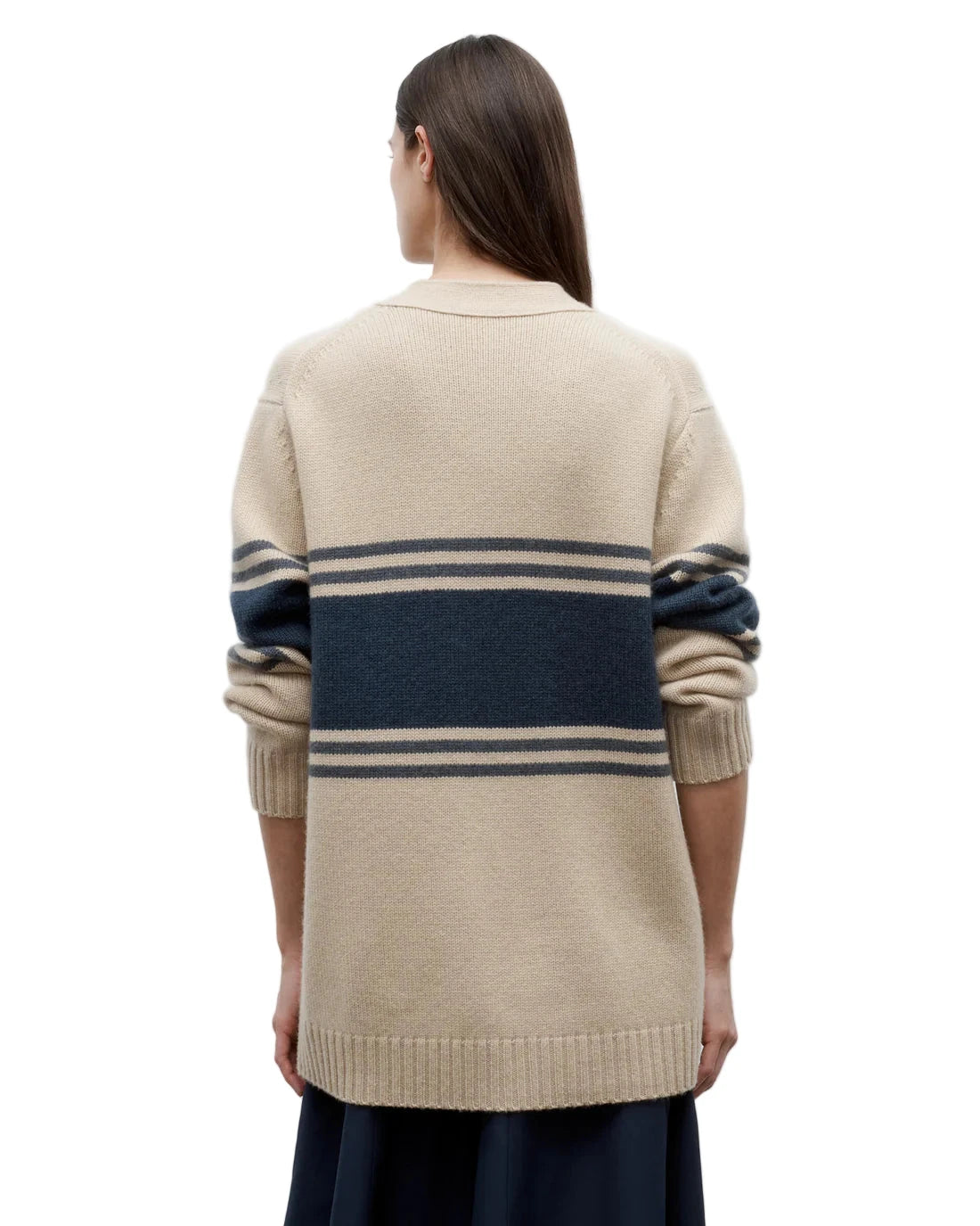 Lifestyle image of the Varsity Phoebe Sweater in Twine styled with side pockets, perfect for a relaxed look.