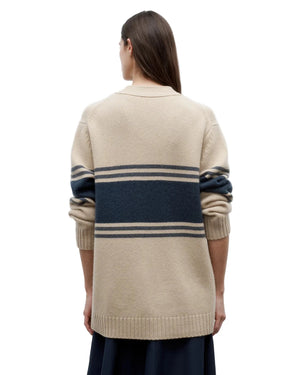 Lifestyle image of the Varsity Phoebe Sweater in Twine styled with side pockets, perfect for a relaxed look.