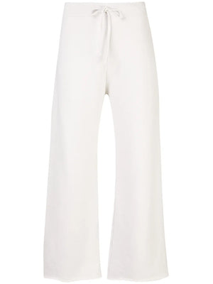 Nili Lotan Kiki Sweatpant in Chalk showcasing a wide cropped leg and flared raw-edge bottom, perfect for lounging or errands.
