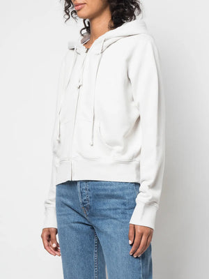 Model wearing the Callie Hoodie in Chalk from Nili Lotan, highlighting the center front draw cord and stylish design.
