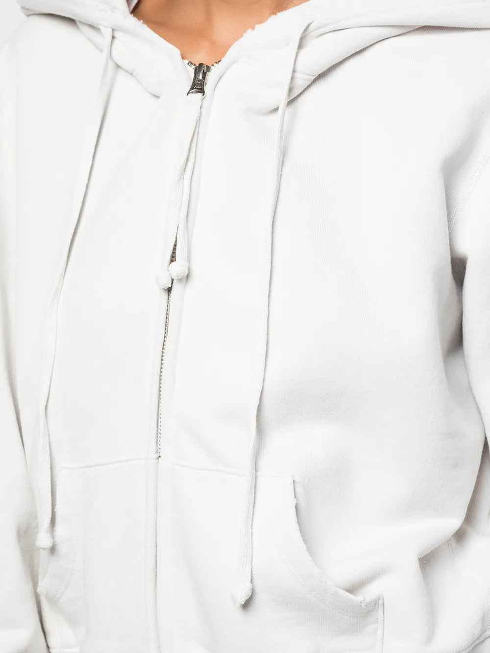 Lifestyle shot of the Callie Hoodie in Chalk by Nili Lotan in an outdoor setting, perfect for casual wear.
