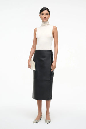 Stunning close-up of the Roman Leather Wrap Skirt in Black by Staud, highlighting the supple calfskin leather.