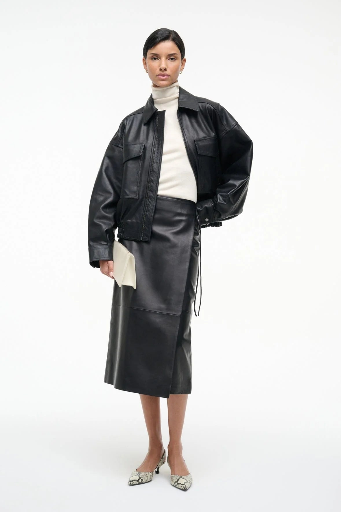 Fashion-forward look featuring the Roman Leather Wrap Skirt in Black by Staud paired with trendy accessories.