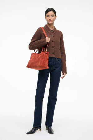 Maude Satchel in Auburn Suede showing the front pocket, perfect for phones.