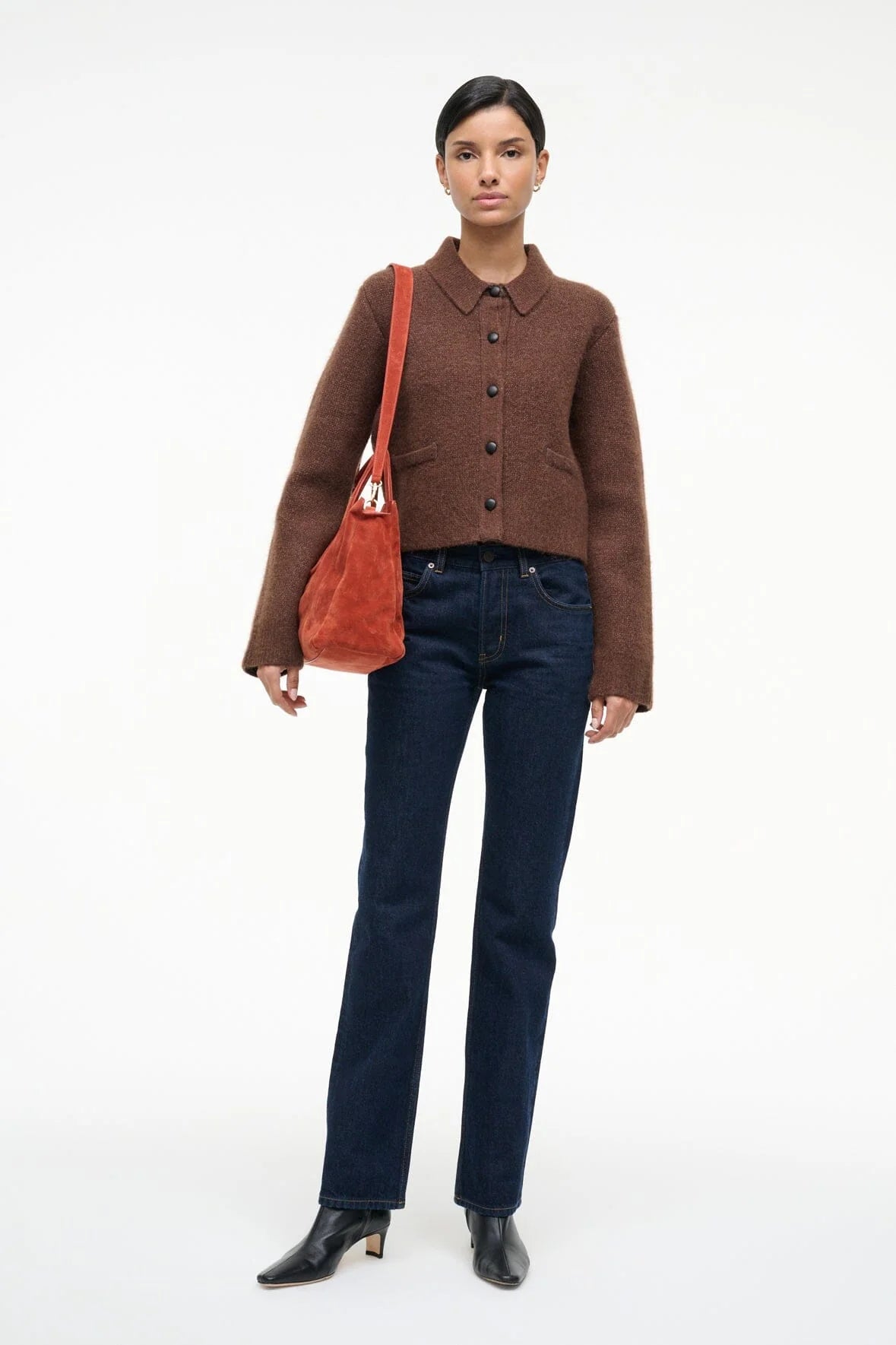 Side view of the Maude Satchel in Auburn Suede, emphasizing its slouchy style.