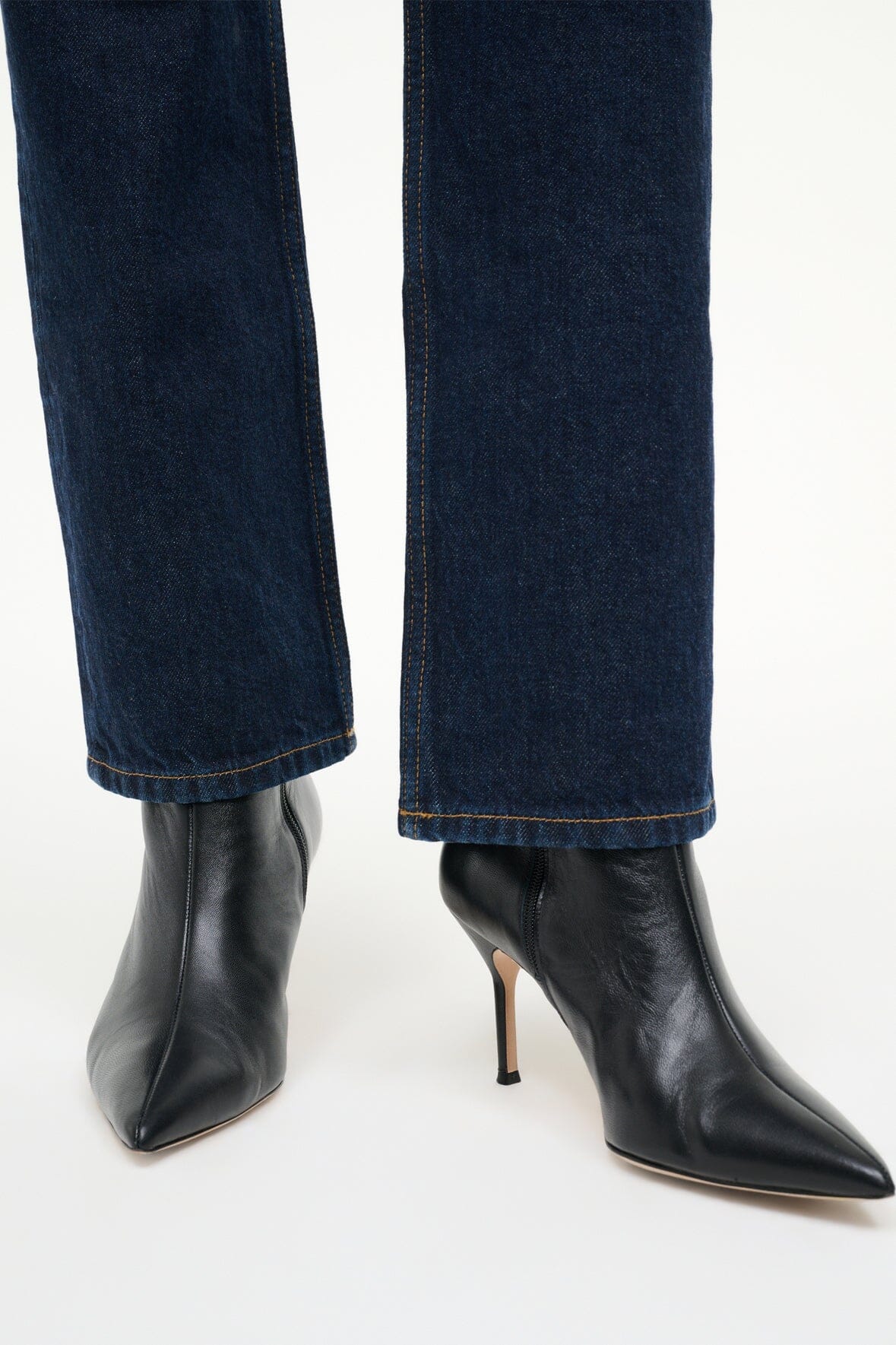 Detailed shot of Staud Sebastian Ankle Boot in black showcasing soft cow leather.
