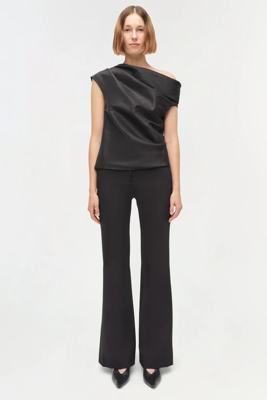 Close-up view of the fabric of the Vivia Taffeta Draped Top in Black, highlighting its luxurious taffeta texture.