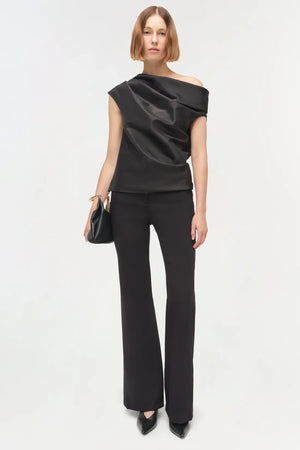 Detail shot of the shoulder of the Vivia Taffeta Draped Top in Black, featuring its distinctive draped design.