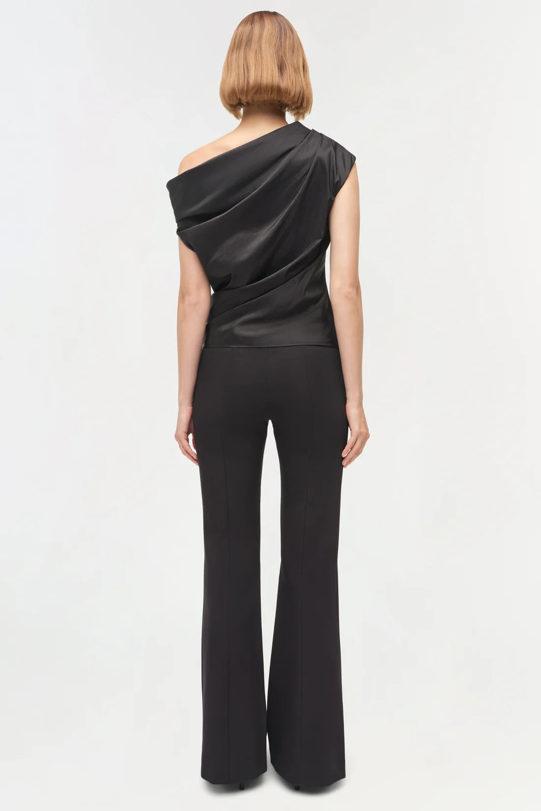 Model wearing the Vivia Taffeta Draped Top in Black, styled with chic accessories, perfect for a night out.