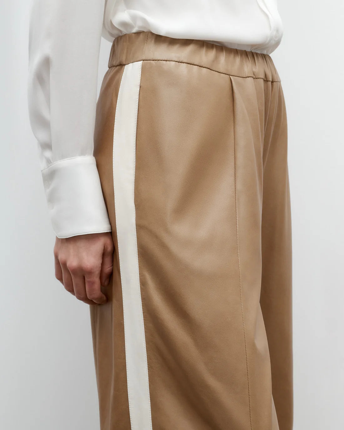 Flat lay of the Eva with Tux Pant in Kelp/Bone, highlighting the 100% leather composition and elegant design.