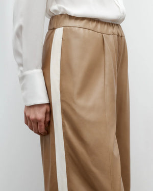 Flat lay of the Eva with Tux Pant in Kelp/Bone, highlighting the 100% leather composition and elegant design.
