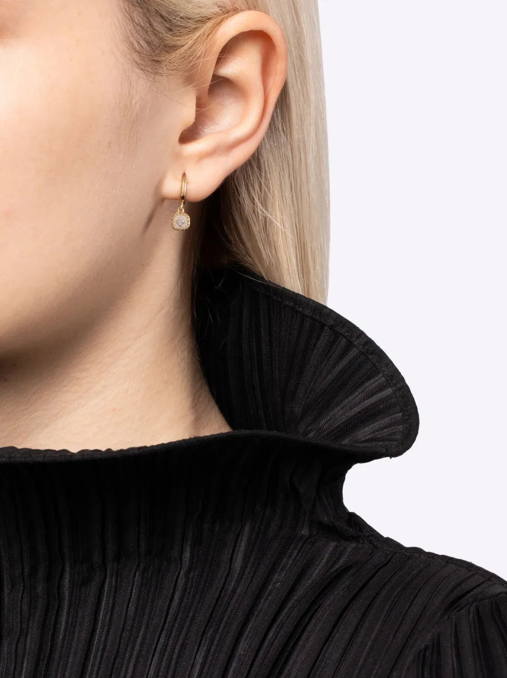 Pierrot Hoops in White by Pascale Monvoisin showcasing small yellow gold hoop earrings with a tiny black pendant.