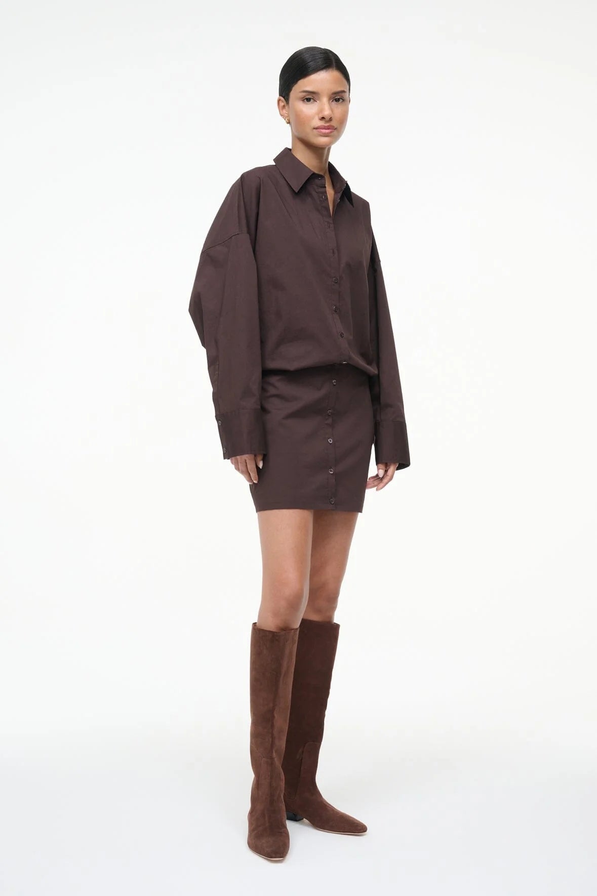 Model wearing the Cynthia Dress in Earth by Staud, beautifully styled with long sleeves and a mini skirt for a chic look.