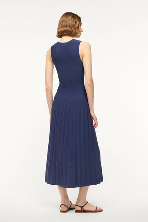 Elyse Dress in Navy featured in a fashion setting, ideal for summer styling and trendy ensembles.