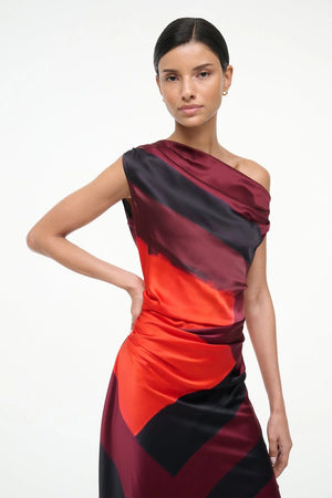 Elegant display of Staud's Phare Silk Dress in Ruby Prism against a soft backdrop.