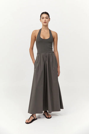 Model wearing the Halter Gathered Dress in Khaki, demonstrating the elegant flow of this versatile halter maxi dress.