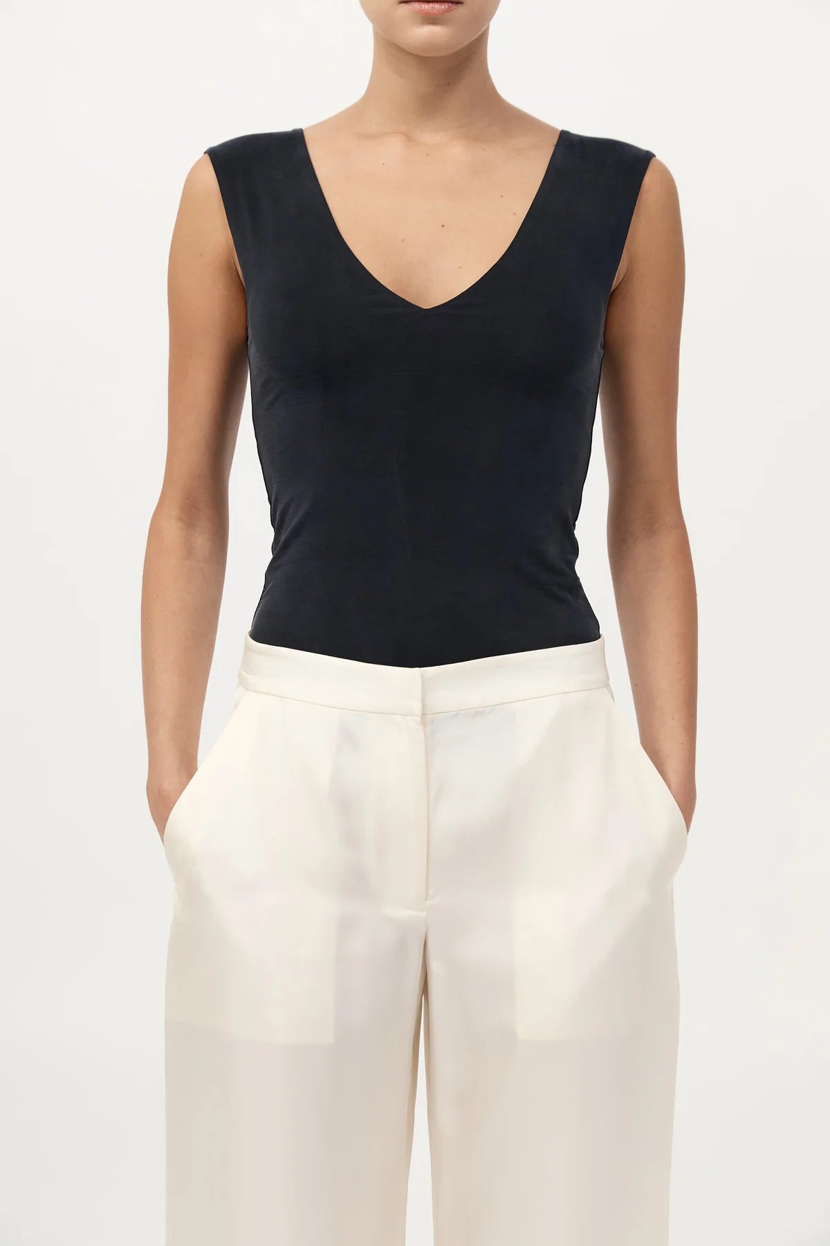 Model wearing the 90s Cupro Top in Black by St. Agni, showcasing its versatile design and flattering silhouette.