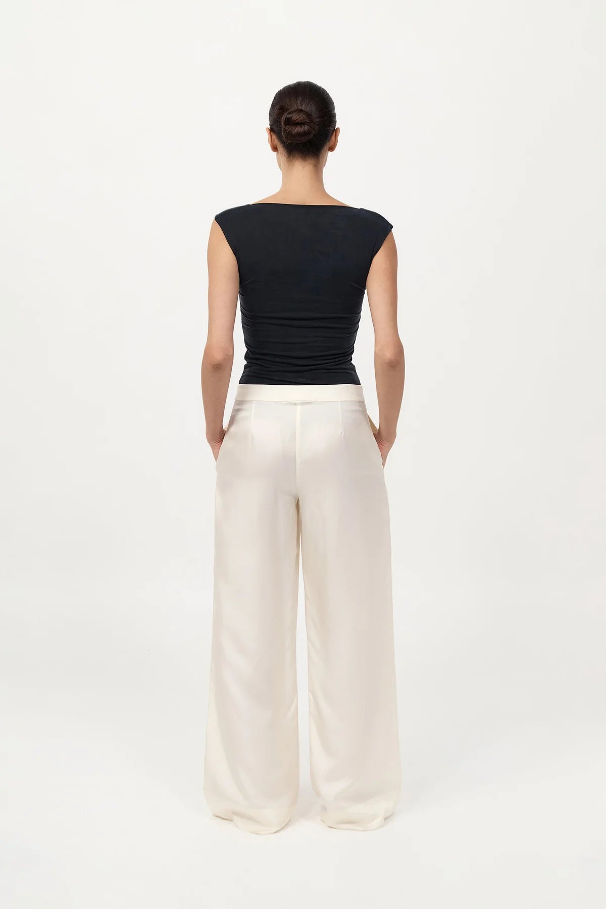 Stylish outfit featuring the 90s Cupro Top in Black paired with minimal accessories, ideal for effortless fashion looks.