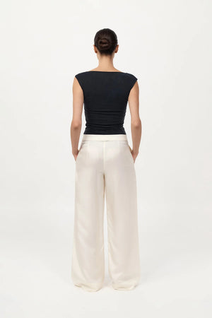 Stylish outfit featuring the 90s Cupro Top in Black paired with minimal accessories, ideal for effortless fashion looks.