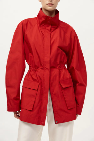 Lifestyle shot of the St. Agni Paper Taffeta Parka in Red worn during a casual outing, perfect for transitional climates.