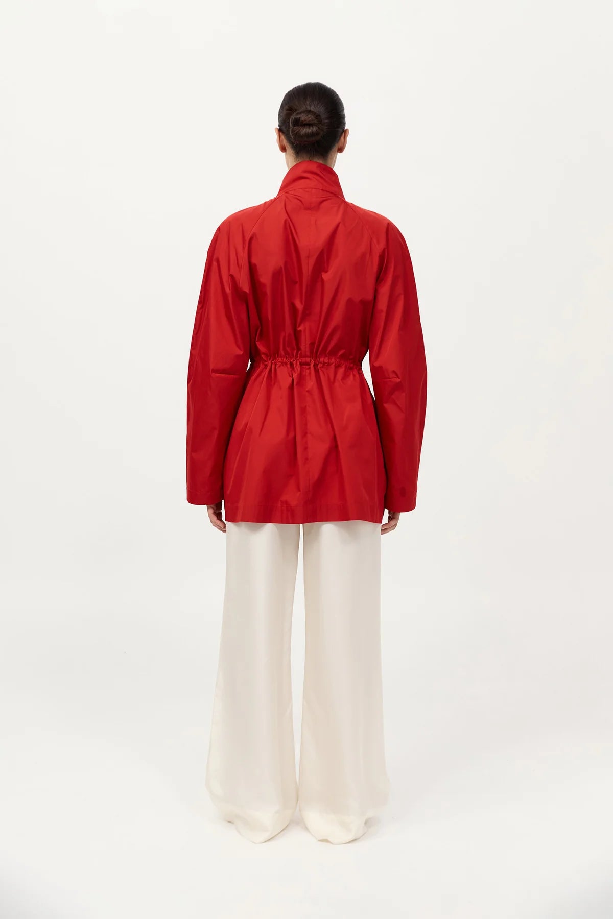 Back view of the Paper Taffeta Parka in Red by St. Agni, highlighting its raglan sleeves and unlined feature.