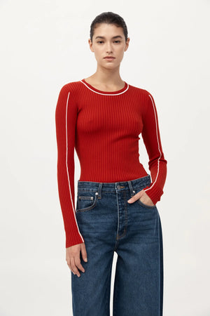 Side view of the Fine Line Long Sleeve Top in Red/Off White showing the fabric draping beautifully on the model.