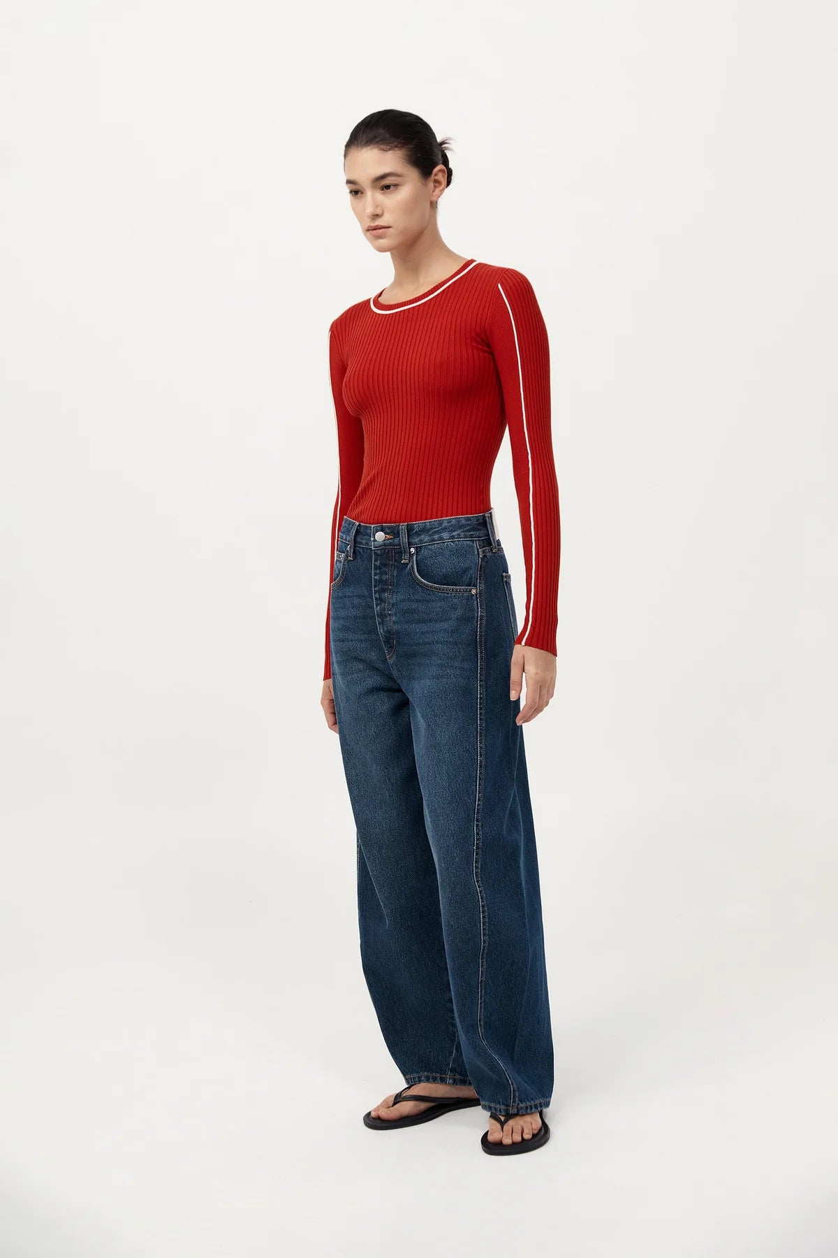 Model wearing the Fine Line Long Sleeve Top in Red/Off White layered with the Fine Line Halter Top for versatile styling.