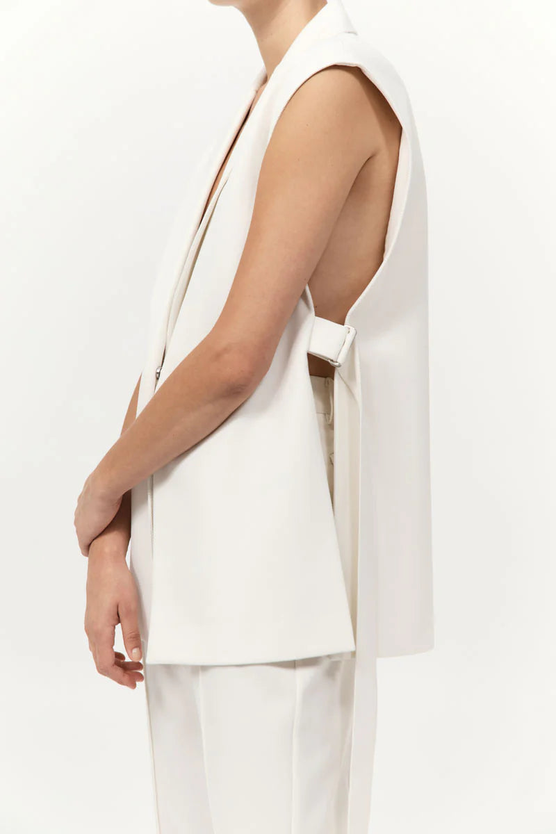 Flat lay of the Relaxed Side Tie Vest in Off White alongside accessories, highlight fashion versatility by St. Agni.