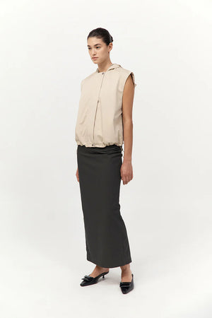 The Cotton Sleeveless Parka in Champagne, illustrating its practical side seam pockets and comfortable internal drawcord, perfect for a sleeveless parka coat.