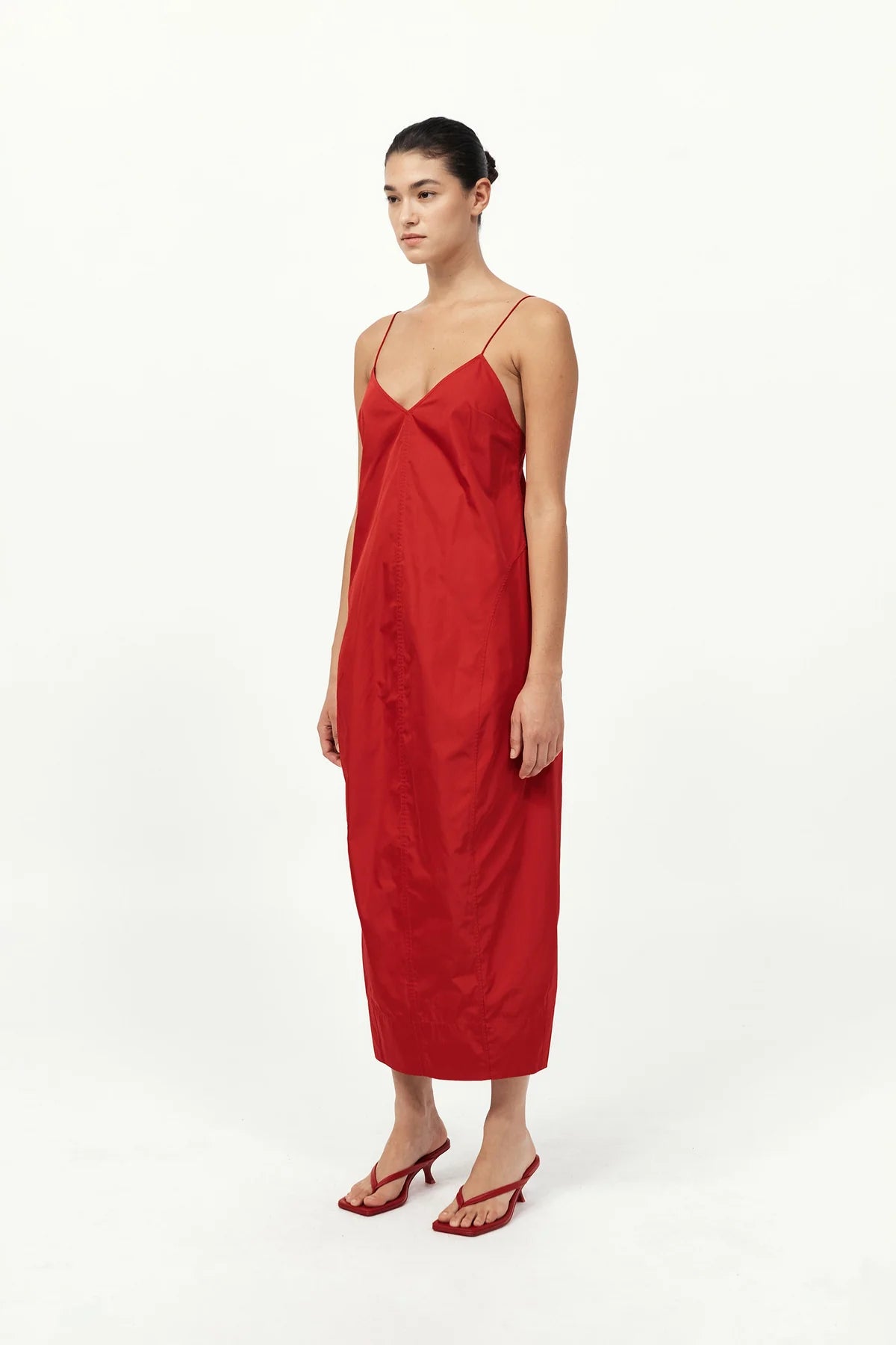Model wearing the Paper Taffeta Cocoon Dress in Red by St. Agni, highlighting its fluid silhouette and contemporary design.