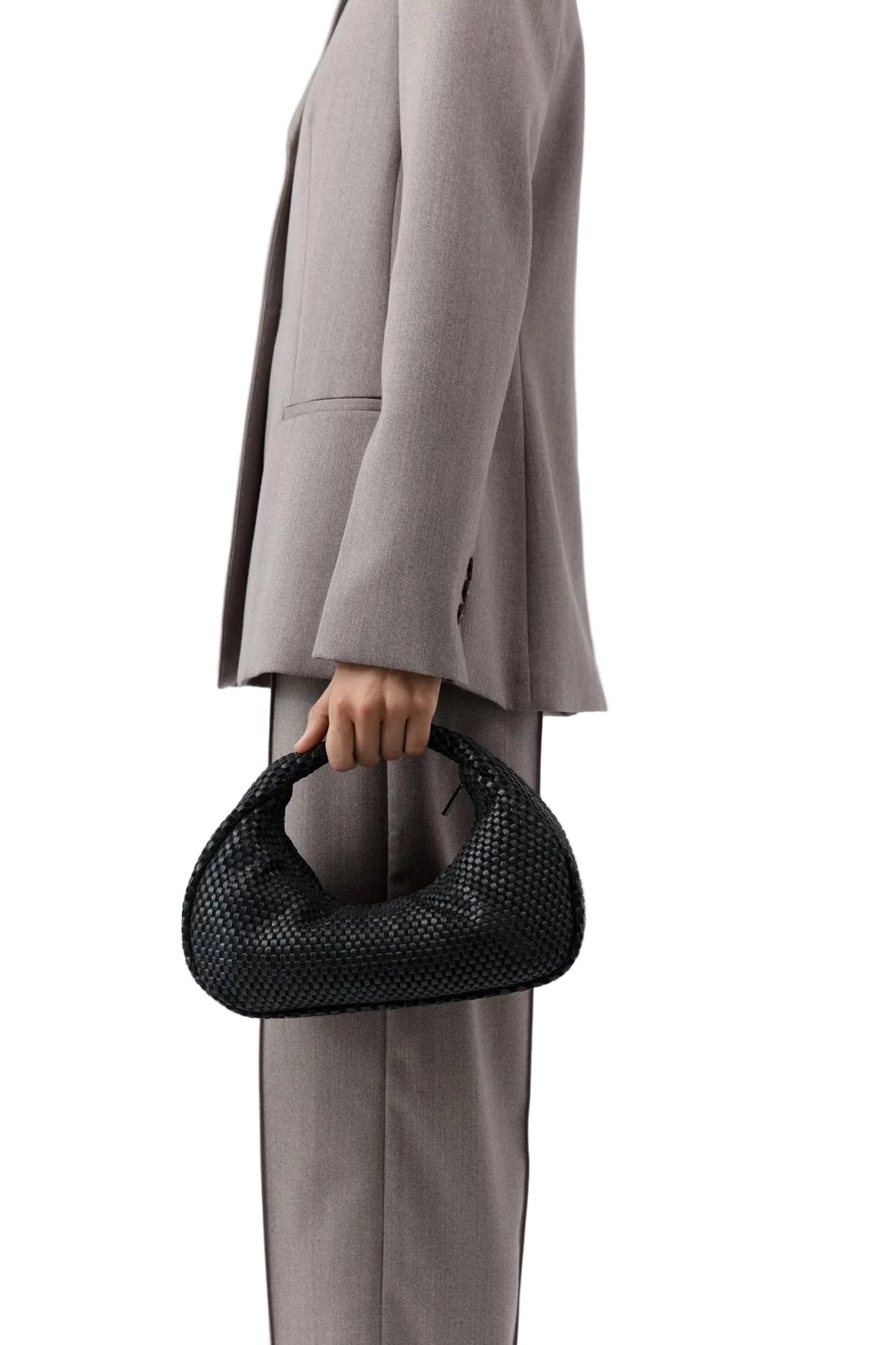 Lattice Weave Bon Bon Bag in Black displayed on a minimalist setup, perfect for elevating elegant outfits.