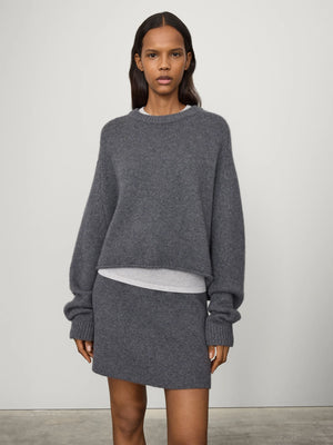 Side view of the Karine Sweater in Graphite, illustrating the dropped shoulders and elongated raglan sleeves.