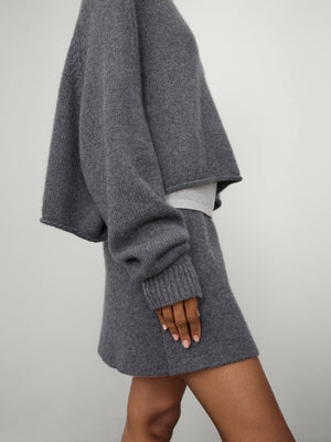 Lifestyle image of the Karine Sweater in Graphite worn casually, perfect for a relaxed outfit.