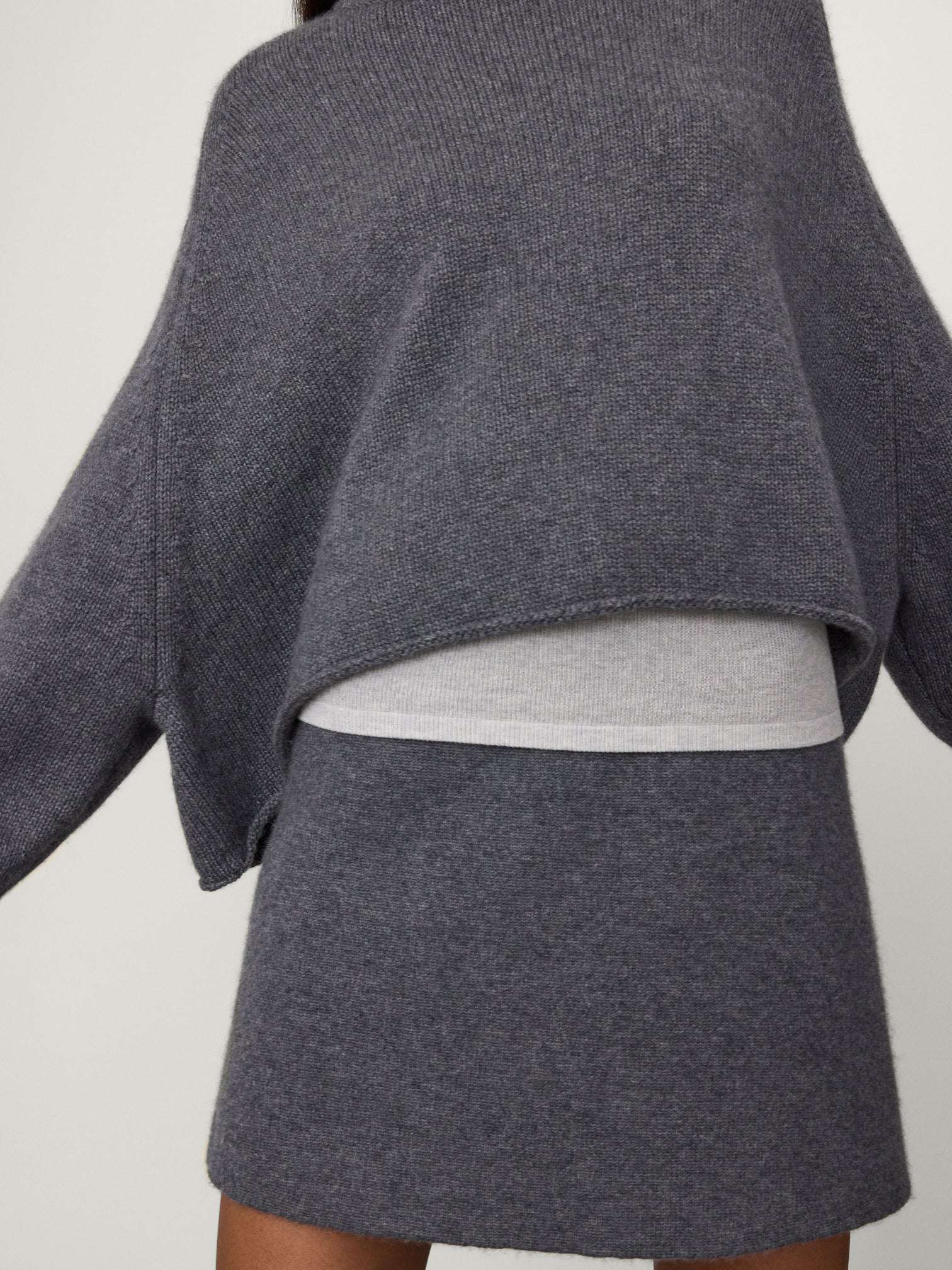 Flat lay of the Karine Sweater in Graphite, made from 100% cashmere, showcasing its high-quality composition.
