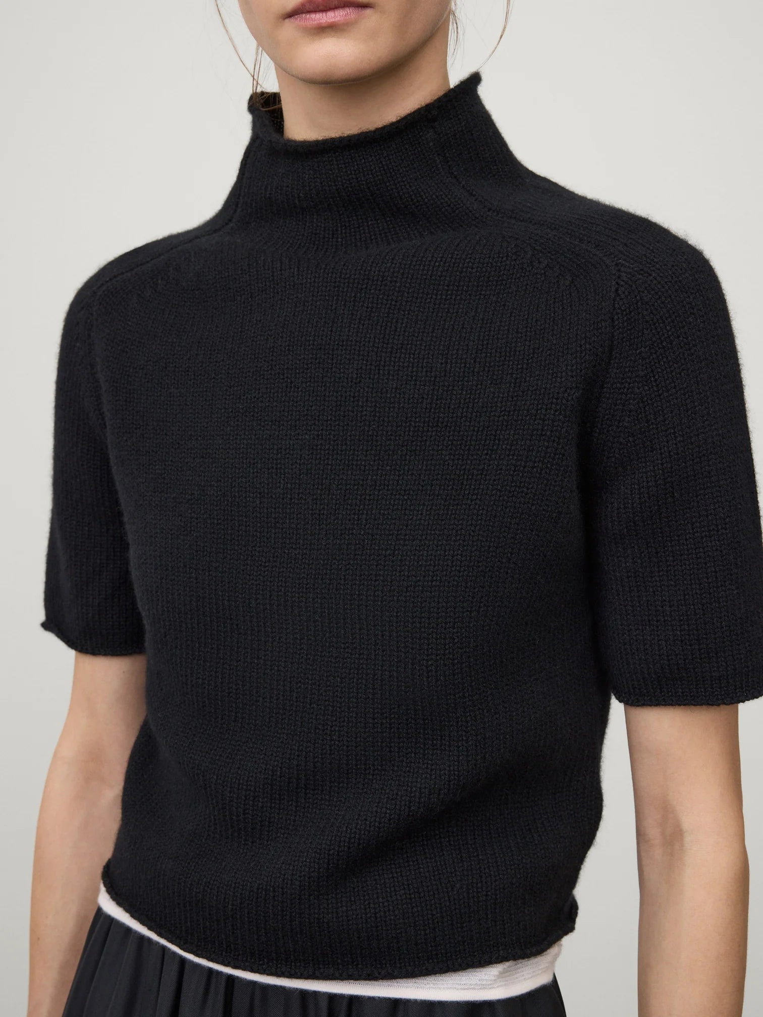 Lifestyle shot of the Fride Sweater in Black by Lisa Yang styled with casual wear, perfect for transitional seasons.